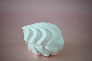 White marshmallows on a pink background.