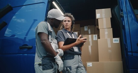 Outside of Logistics Retail Warehouse: African American Worker and Female Inventory Specialist...