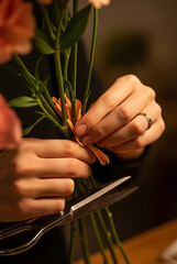 Warmly Lit Close-Up of Florist Crafting Flower Bouquet