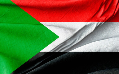 Flag of Sudan in Vibrant Colors Displayed on Textured Fabric Background