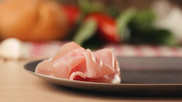 Ham italian mordatella, man Slices Of Traditional Italian antipasti mortadella sausage on a wooden cutting board, close up macro of chicken or turkey jamon, fat breakfast dish.