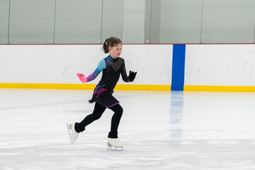 Figure skating practice at an indoor skating rink