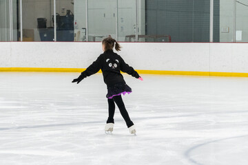 Figure skating practice at an indoor skating rink