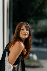 Young caucasian female with red hair posing outdoors