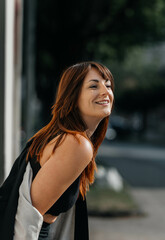 Smiling young caucasian female outdoors with red hair