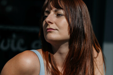 Confident young caucasian female with long brown hair in natural light