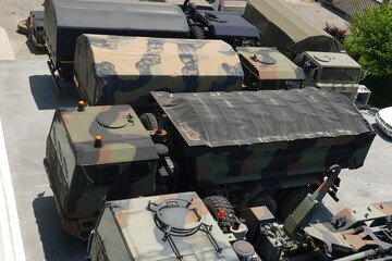 A large collection of military equipment in one place. The collection includes various types of...