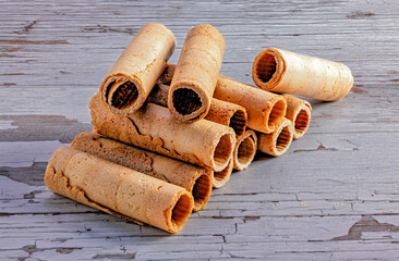 Crunchy wafer rolls on rustic background