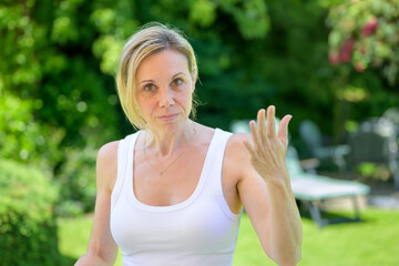 Woman Gesturing In Conversation Outdoors