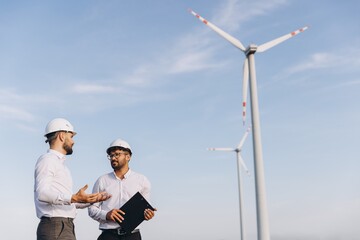 Engineers discussing about a wind turbine project for sustainable energy production