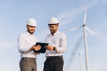 Engineers discussing a project in a wind turbine power plant