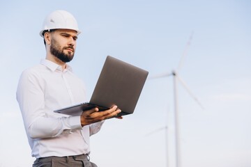Engineer working with laptop in a wind turbine power plant