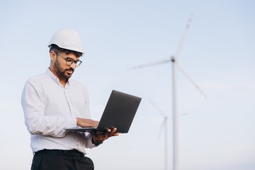 Engineer working with laptop in a wind turbine power plant
