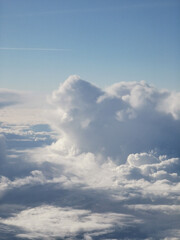 Expansive view of fluffy white clouds against a bright blue sky, showcasing the beauty of nature and the vastness of the atmosphere in a serene and tranquil setting