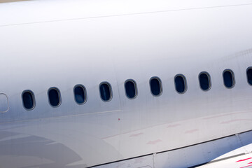 Close-up of windows of passenger airplane taxiing at Swiss Airport Z&uuml;rich Kloten on a sunny spring day. Photo taken May 10th, 2025, Zurich Kloten, Switzerland.