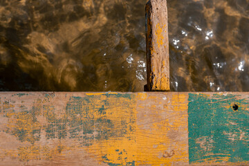 old wooden pier with water in the background
