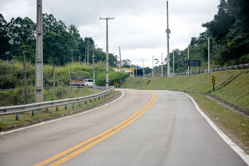 Sinalização rodoviária indicando pedágio a 1 km com opção de cobrança automática à direita. Foto ideal para temas de mobilidade, transporte rodoviário e infraestrutura no Brasil.