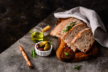 Fresh bread, olive oil and mix of olives.