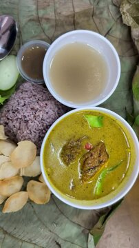 Top view of linopot rice and ayam masak lemak cili padi chicken cooked in a spicy coconut milk curry Sabah cuisine