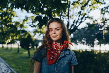 lifestyle woman in modern boho-western denim street style wearing a red bandana with natural...