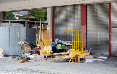 Construction debris and discarded materials near industrial building entrance