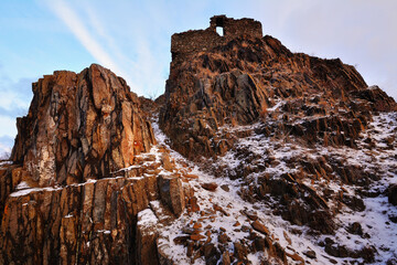 Snow-Dusted Castle Ruins on Basalt Pillars in Morning Light