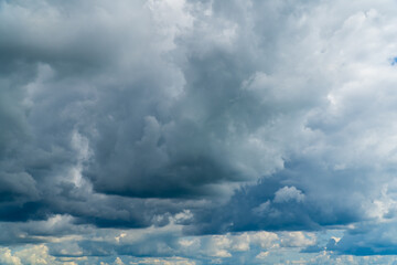 Stormy sky with dark, snowy clouds on a spring day. Clouds are floating across the sky. Dark blue...
