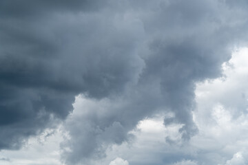 Stormy sky with dark, snowy clouds on a spring day. Clouds are floating across the sky. Dark blue...
