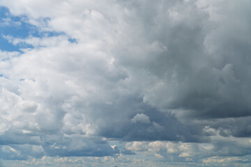 Stormy sky with dark, snowy clouds on a spring day. Clouds are floating across the sky. Dark blue...