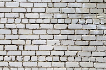 Brick wall painted in bright colors.	