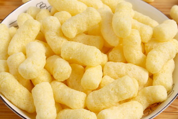 There are many sweet corn sticks on the plate.