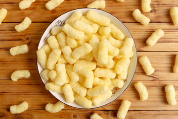 There are many sweet corn sticks on the plate.