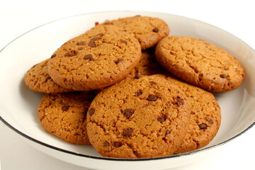 There are a lot of oatmeal cookies on the plate.