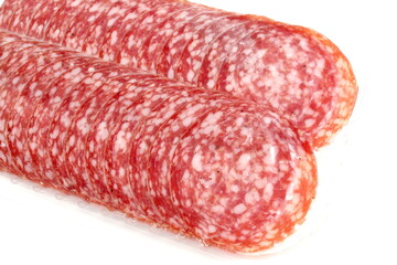 There are many pieces of salami in a transparent package.