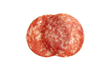 Round pieces of salami lie on a white background.