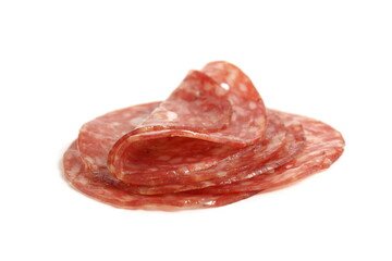  Round pieces of salami lie on a white background.