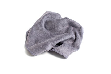 A crumpled grey napkin lies on a white background.	