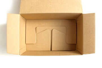 A brown cardboard empty box stands on a white background.