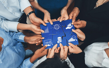 A dynamic group of diverse professionals collaborates over a puzzle piece, symbolizing data,...