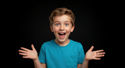 Excited boy with raised hands and open mouth in turquoise shirt against black background. Pure childhood amazement and joy for party celebrations and entertainment promotions