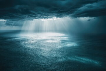 Fototapeta premium Sunlight piercing a stormy sea