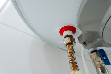 This closeup shows a wellmaintained water heater with a secure hose, emphasizing the importance of...