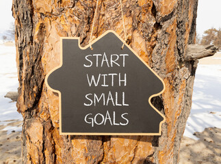 Start with small goals symbol. Concept words phrase Start with small goals on beautiful black...