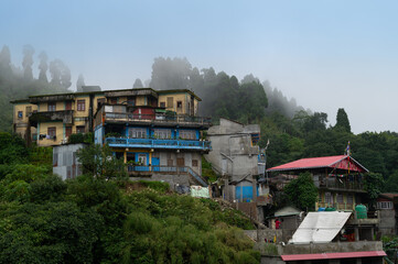Darjeeling,West Bengal,India -11.08.2023 : Beautiful foggy view of houses of Ghum town. Houses are...
