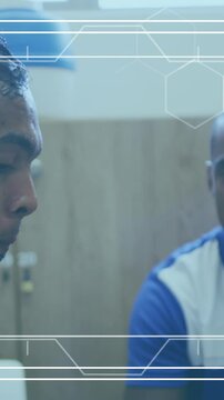 Animation of white frame with markers over football players during break in changing rooms