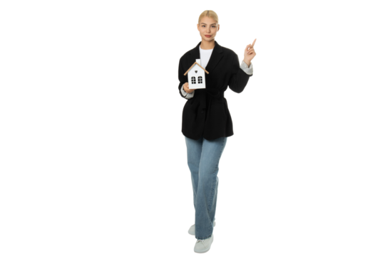 Woman holding house model and pointing – isolated on transparent background, PNG, front view