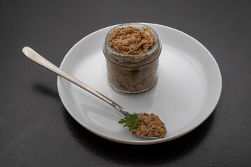 Fresh homemade veal liver pate, chicken pate on a white plate. Delicious homemade food. Options for a buffet.
