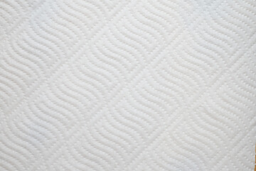 Textured white paper towel surface with wavy pattern
