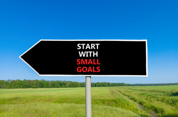 Start with small goals symbol. Concept words phrase Start with small goals on beautiful road sign. Beautiful blue sky green grass lawn background. Business Start with small goals concept. Copy space.