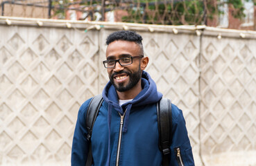 Smiling cheerful adult African American ethnicity man with a beard and glasses. A happy confident...